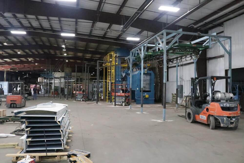 Assembling the additional powder coat line. 